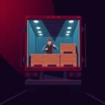 FMCSA Compliance Help for Trucking Companies shown as a truck driver secures cargo inside an open trailer at night